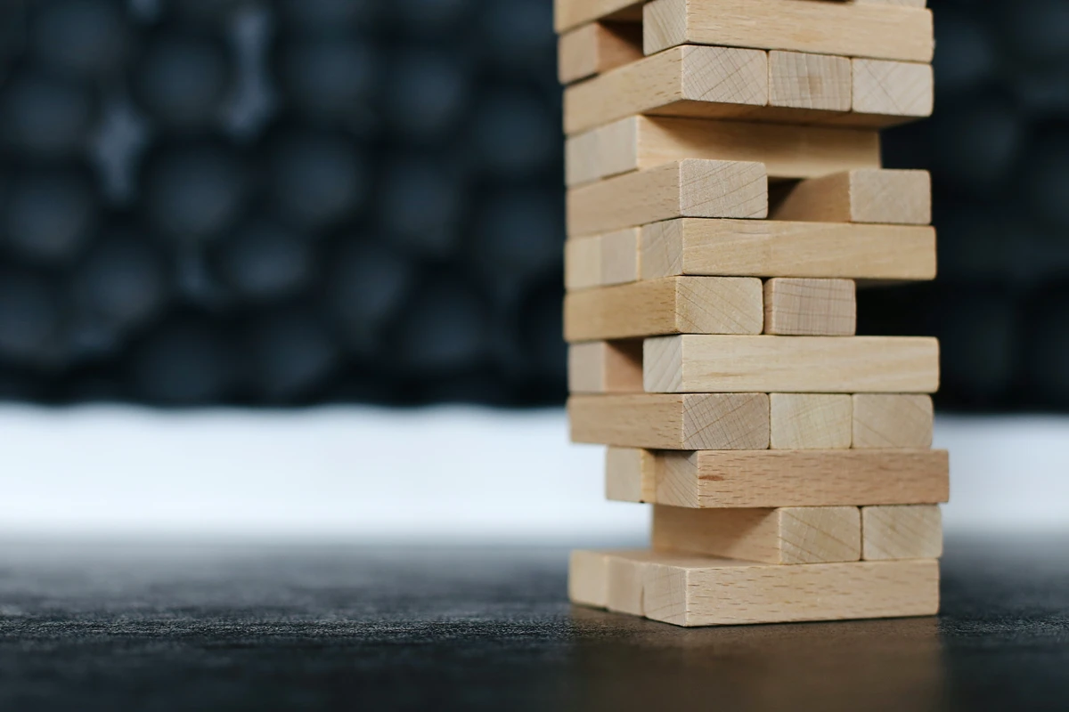 A stacked tower of wooden blocks from the game Jenga.