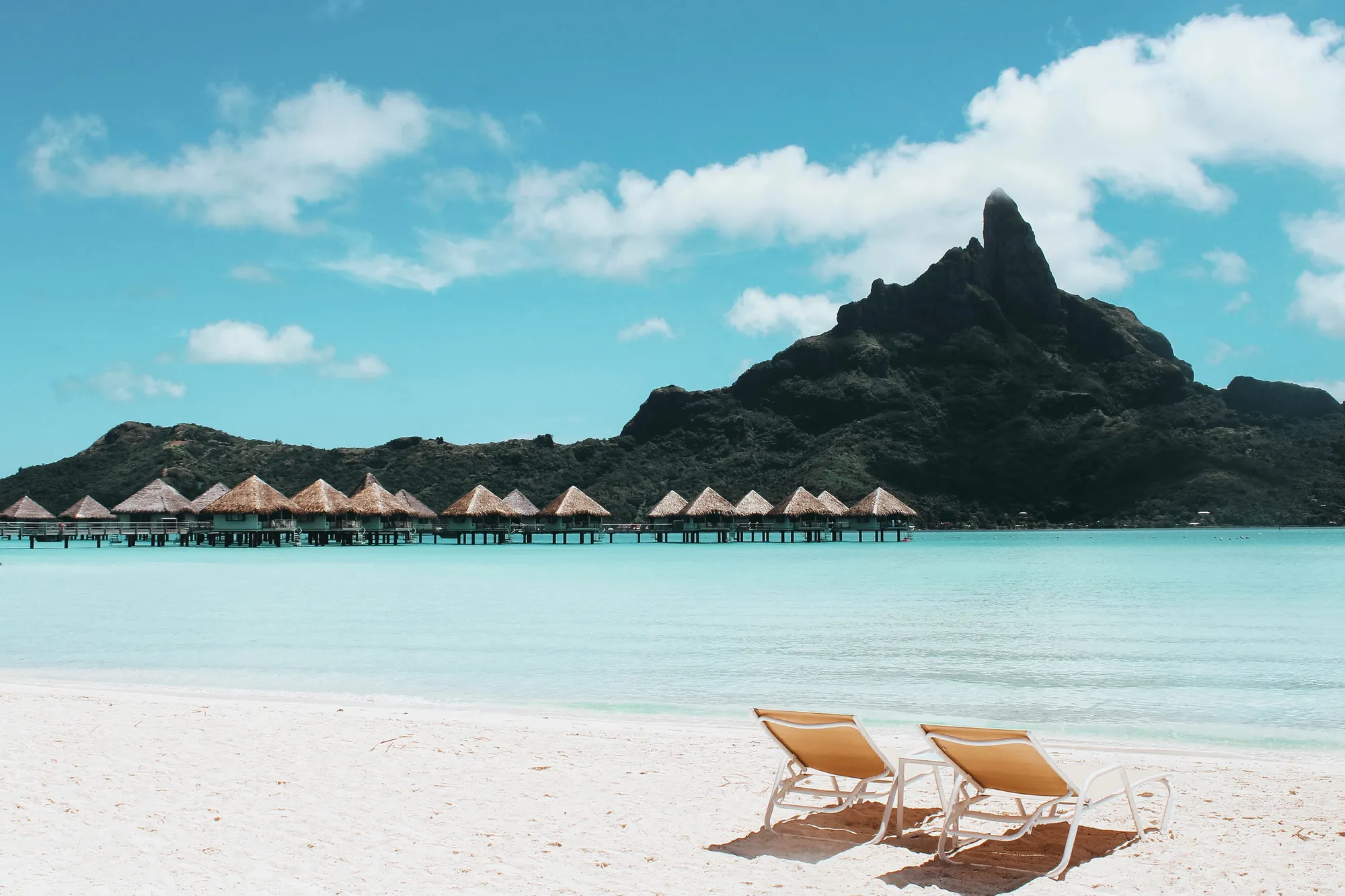 An island with cottages and beach chairs somewhere in French Polynesia